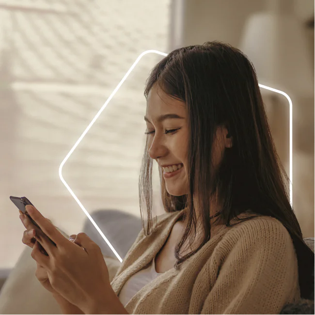 Woman smiling and using a smartphone