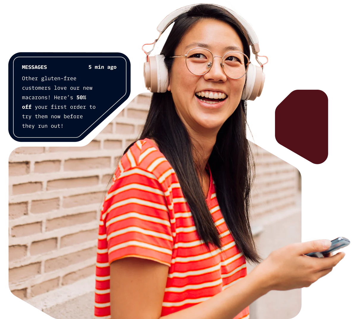 Woman with headphones smiling and holding a phone with a message pop-up about a gluten-free macaron offer.