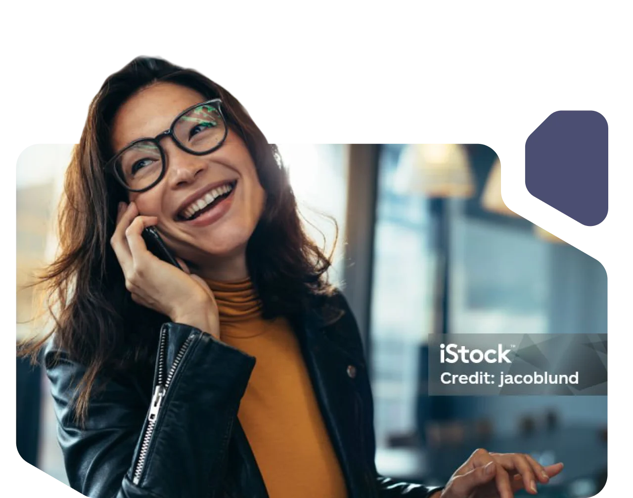 Woman with glasses smiling while talking on the phone