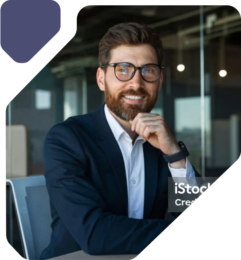Professional Man in Glasses Smiling in Office Man in a suit and tie with glasses smiling in a modern office setting.