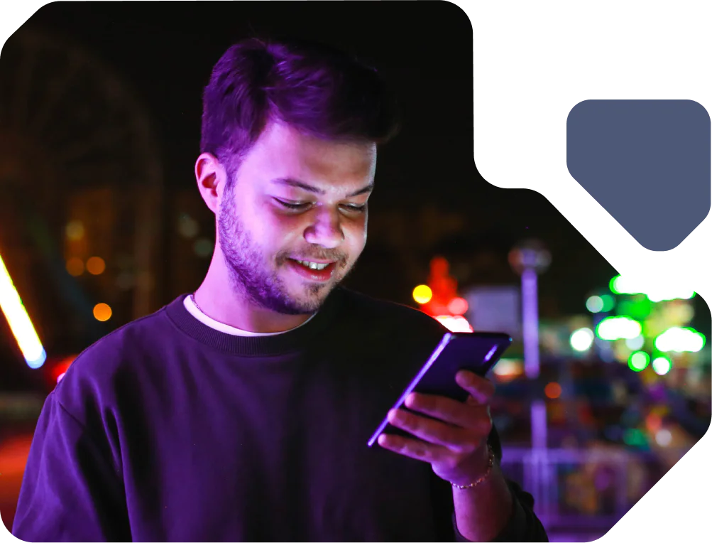 Young Man Enjoys Night Out with Smartphone