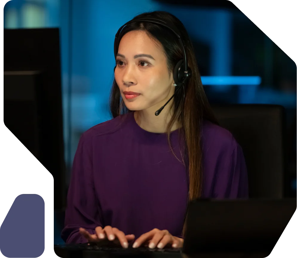 Woman wearing headset working on a computer Woman wearing headset working on a computer