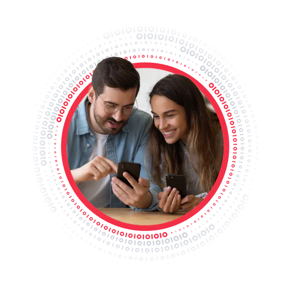 Man and woman smiling while looking at their smartphones, encircled by binary code.