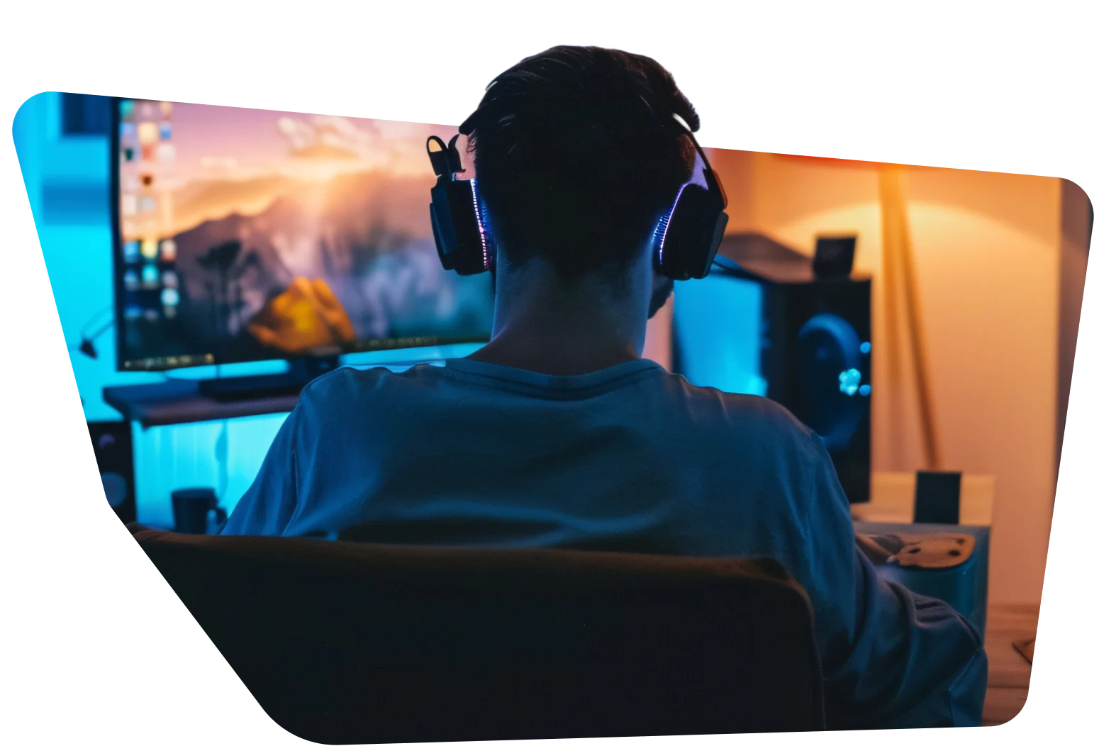 back view of man using modern computer and listening music in headphones at home in neon lights