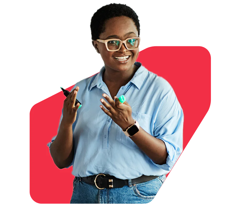 A smiling person wearing glasses and a blue shirt holds a green marker and phone, against a red background.