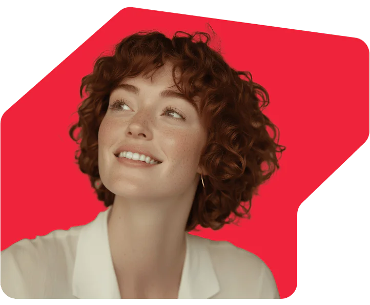 Smiling Woman with Curly Hair on Red Background Woman with short curly hair smiling, set against a bright red background.