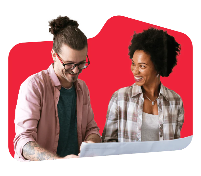 Collaborative work meeting between colleagues. Two colleagues smiling and looking at a document together with a red background.