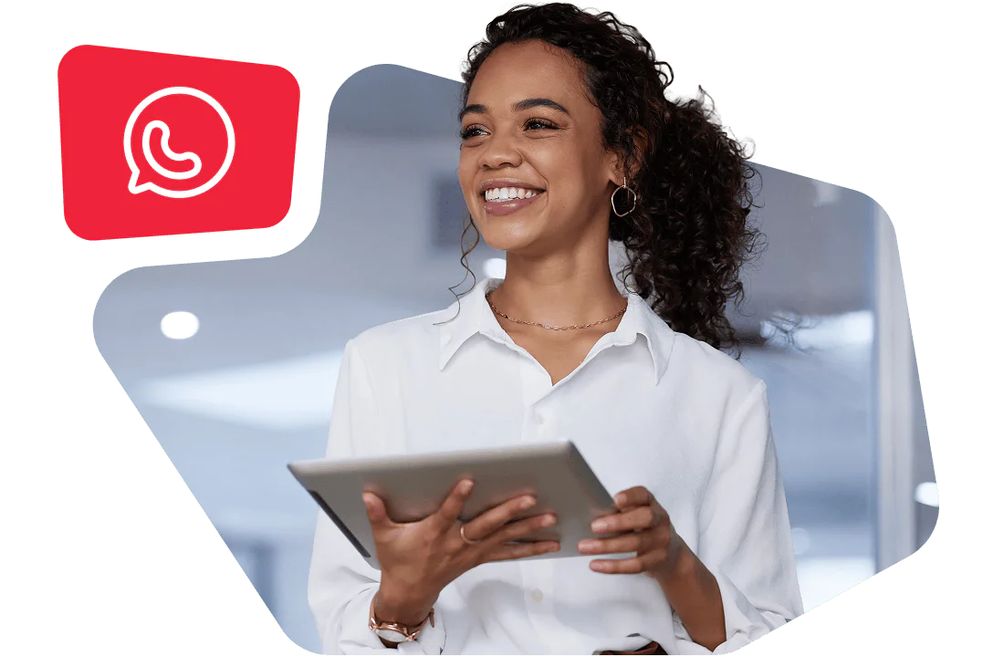 Woman in a white shirt smiles while holding a tablet with a WhatsApp icon in the background