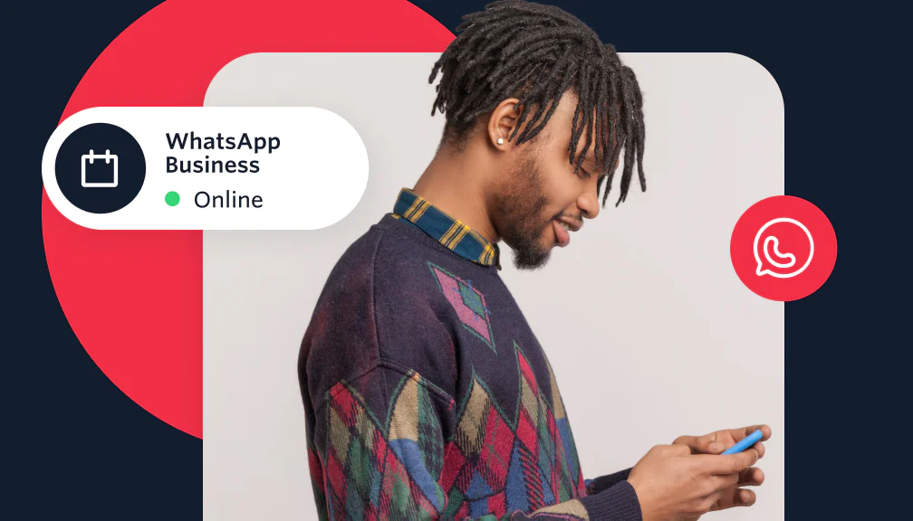 Man looking at a smartphone with WhatsApp Business status displayed online.