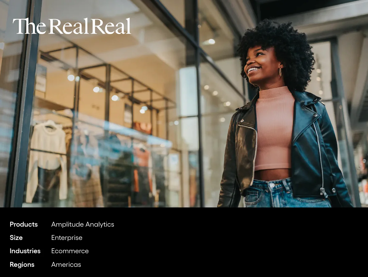 Smiling woman walking past The RealReal storefront