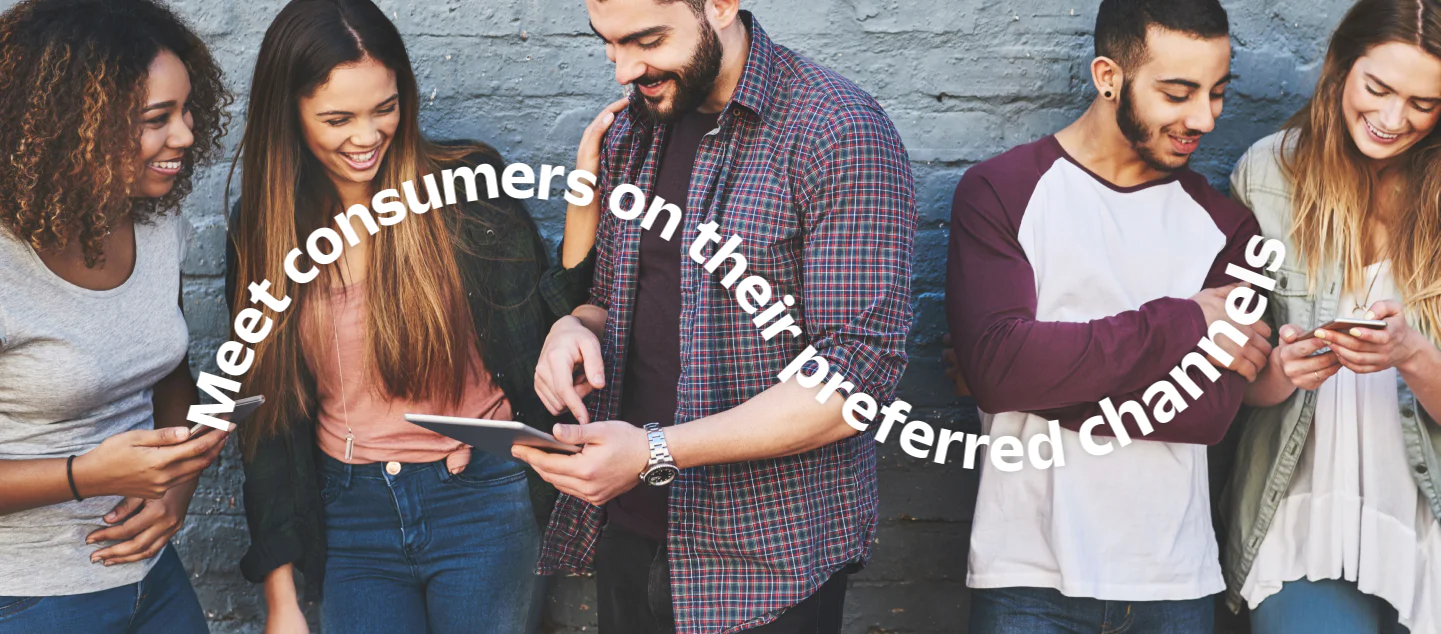 Diverse group of friends looking at mobile devices and tablet, text above says Meet consumers on their preferred channels.