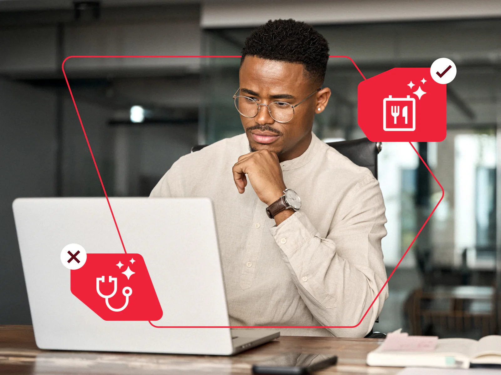 Man in glasses using a laptop with health and dining icons.