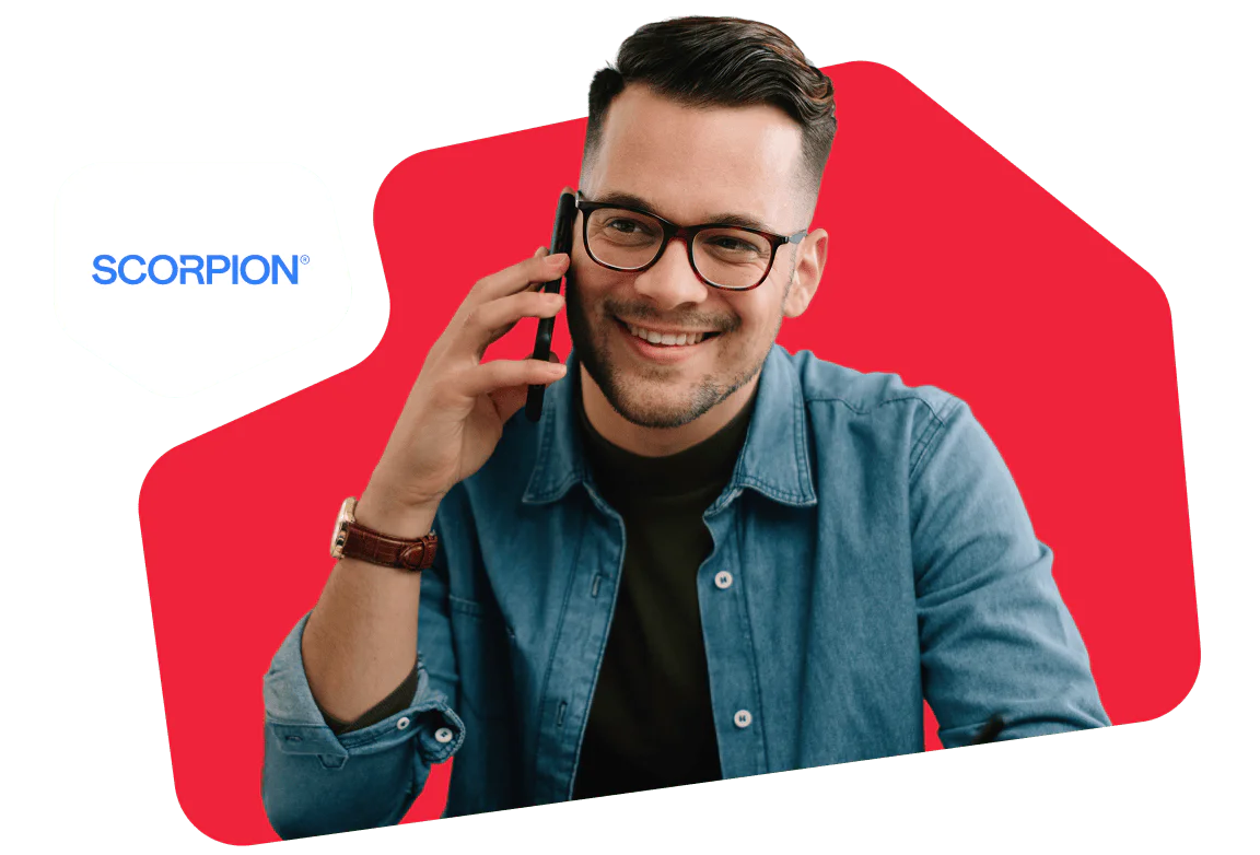Smiling man wearing glasses and denim shirt talking on phone, with Scorpion logo in the corner.