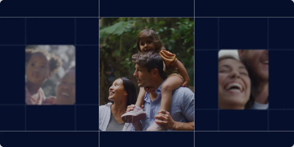 Smiling parents with a child on father's shoulders walking through a green forest.
