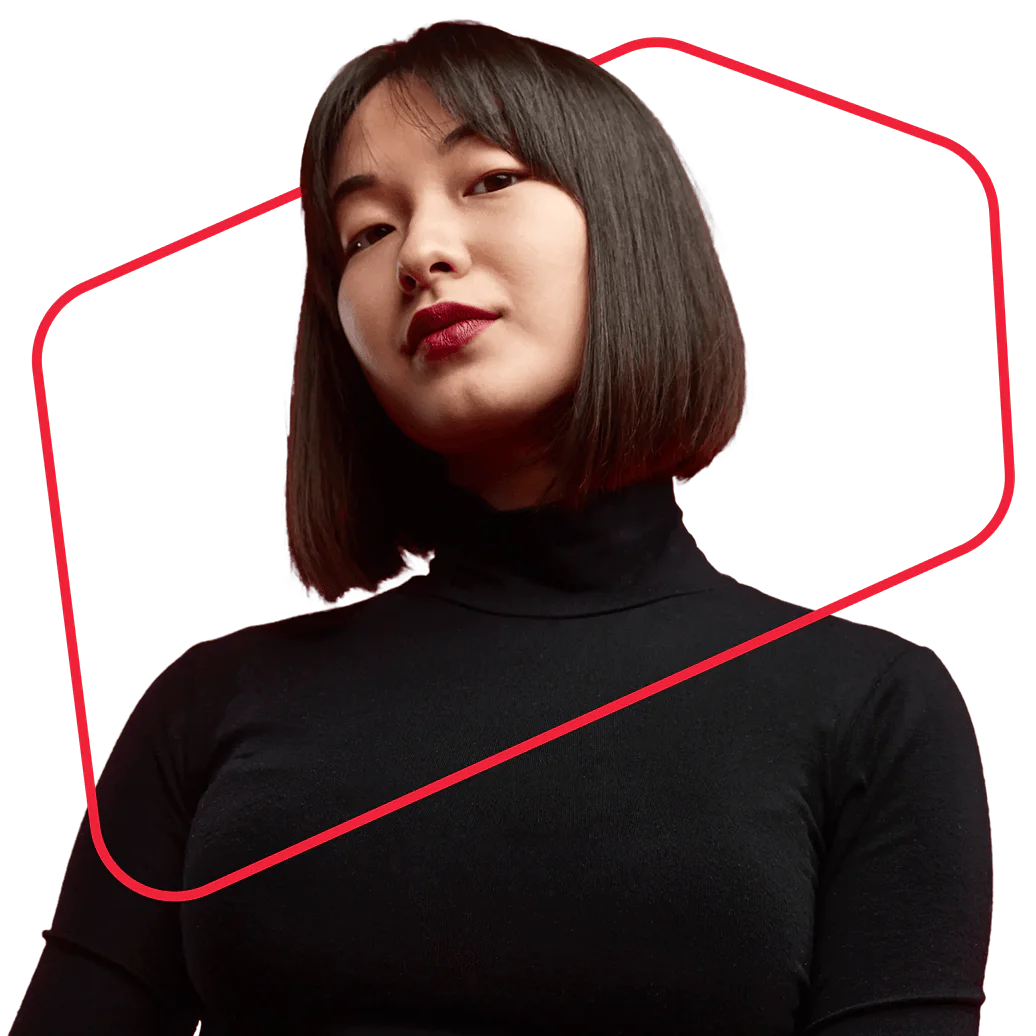 A woman with short dark hair and a black turtleneck, framed by a red geometric shape.