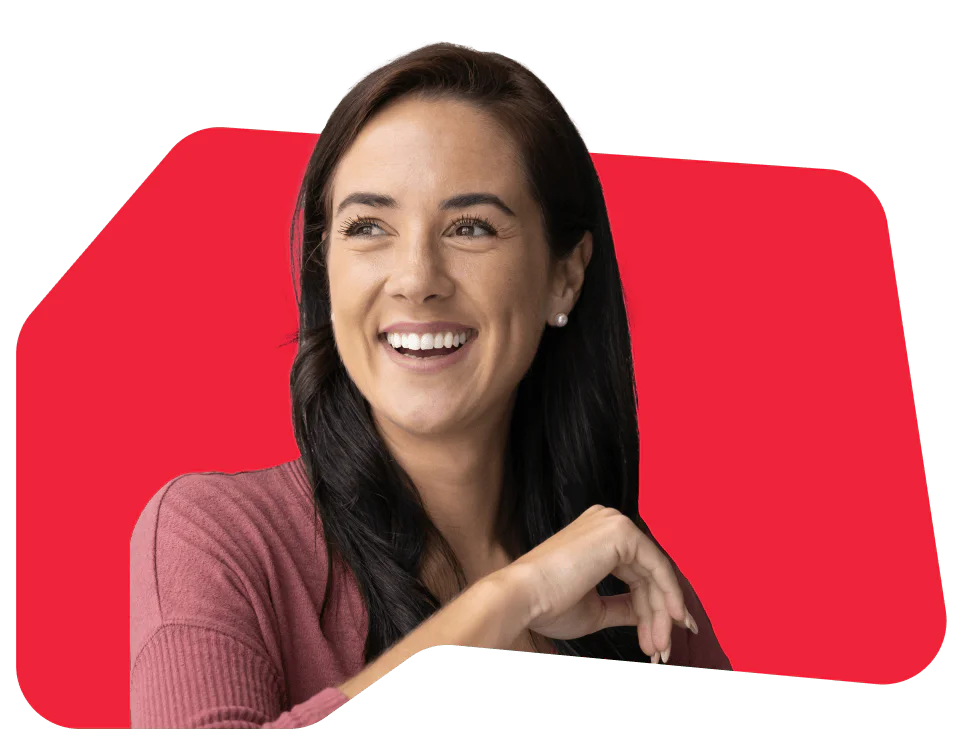 Smiling woman with dark hair against a red background Woman with dark hair smiling and wearing a pink top in front of a red background