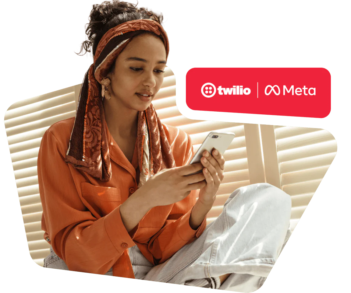 Woman in orange shirt with headband using smartphone, Twilio and Meta logos in the corner