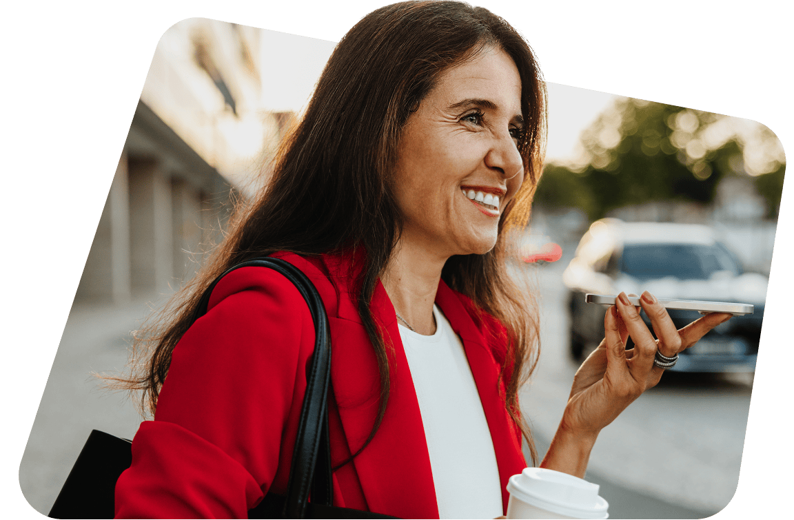 Woman in red blazer talking on phone and holding coffee cup