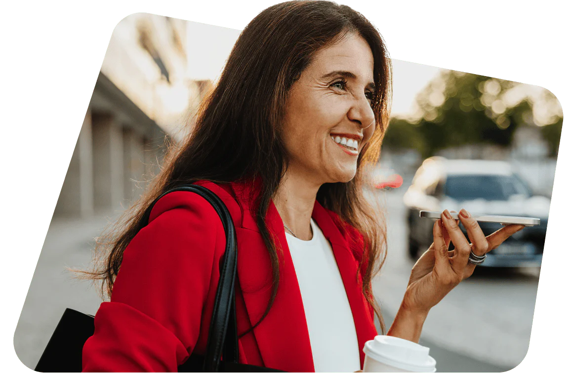 Woman in red blazer talking on phone and holding coffee cup