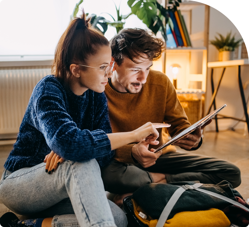 Two people looking at a tablet together