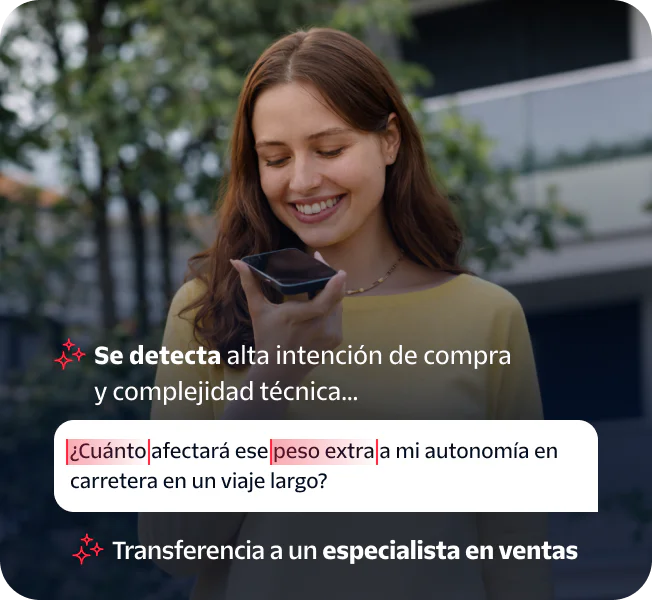 Woman speaking into a smartphone held in her hand while standing outside.