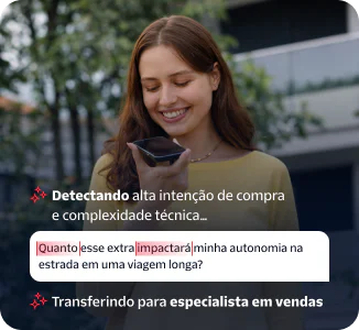 Woman speaking into a smartphone held in her hand while standing outside.