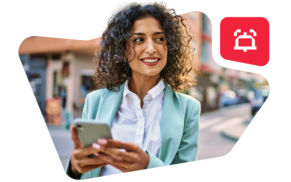 Woman in a teal blazer holding a smartphone with a notification icon in the background.