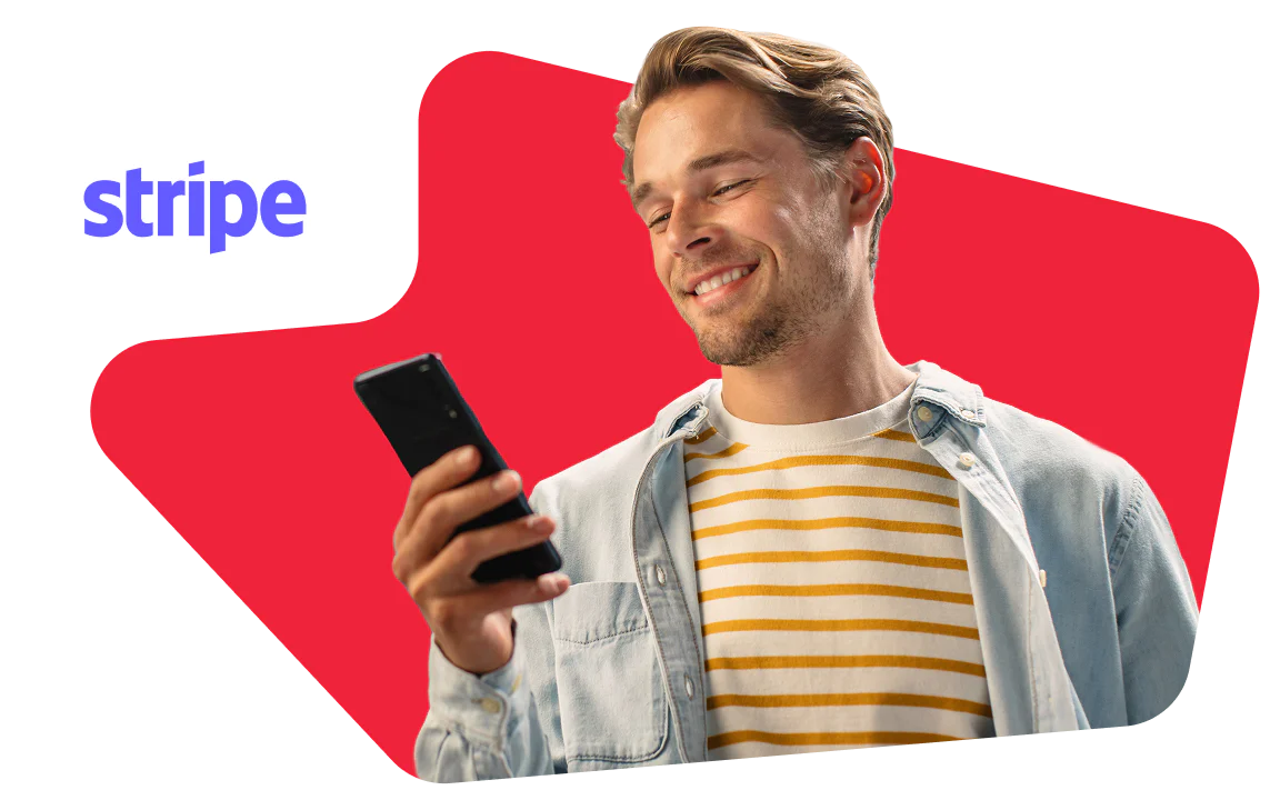 Man smiling and looking at his smartphone, wearing a striped shirt and light jacket, with a Stripe logo.