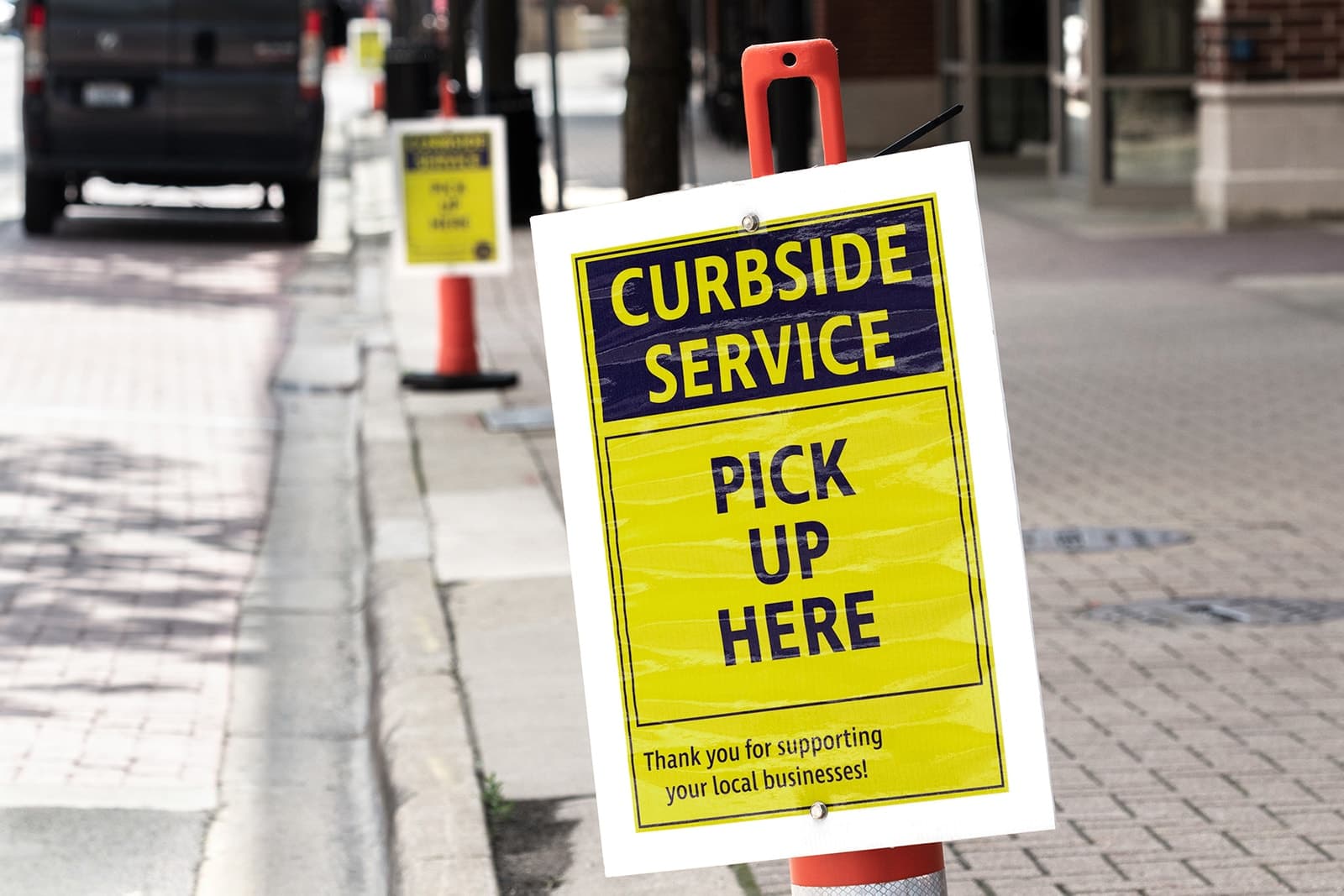Sign on the street indicating curbside service