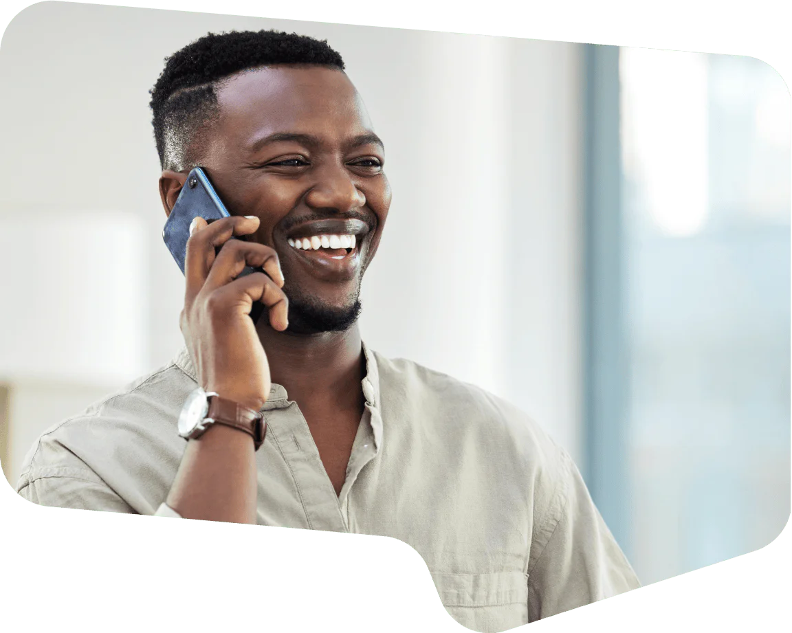 Man Smiling While Talking on the Phone Man with short hair talking on the phone and smiling