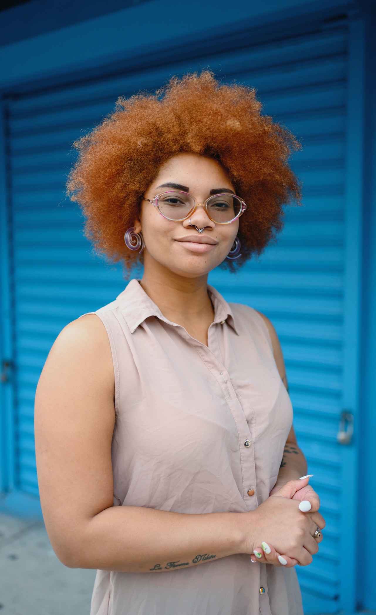 Woman with glasses smiling.